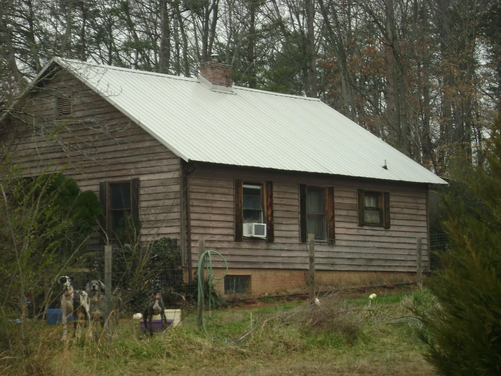 White metal roof on an old wood sided farmhouse, from a Metal Roof Installation job in Point Of Rocks